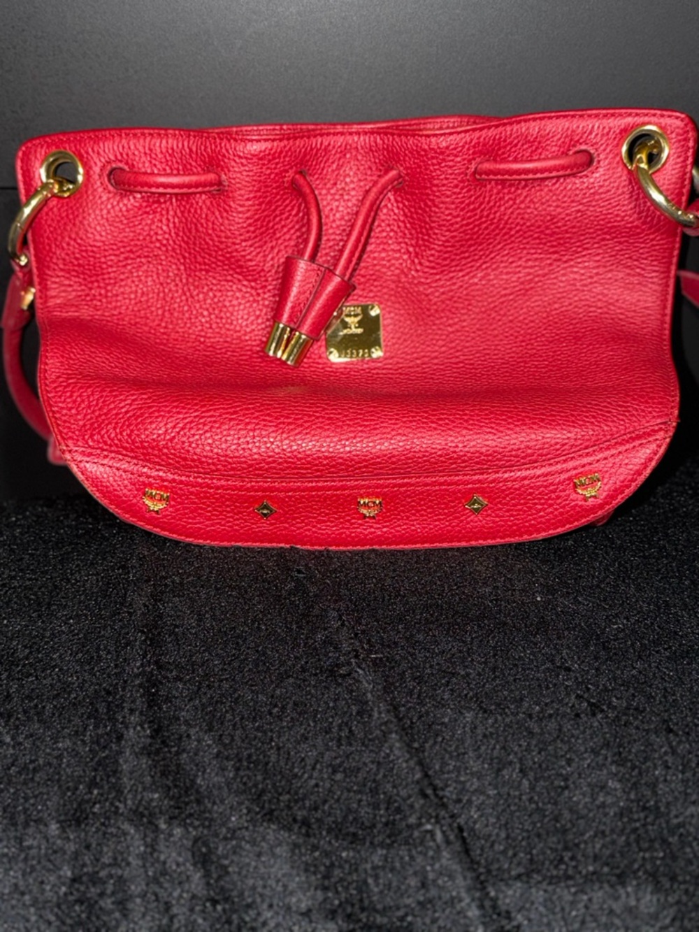 MCM Red Pebbled Leather Drawstring Crossbody with Gold Accents